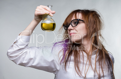 Scientist shaggy woman with yellow liquid