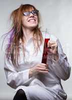 Scientist happy woman with red liquid
