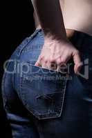 Buttocks and hands in jeans pocket