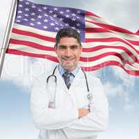 Composite image of smiling male doctor with arms crossed in hospital