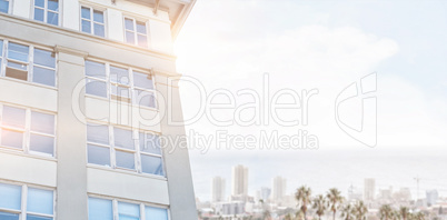 Composite image of modern building against clear blue sky