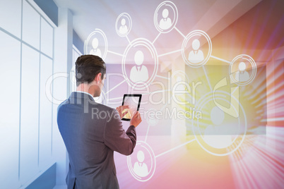 Composite image of businessman using digital tablet