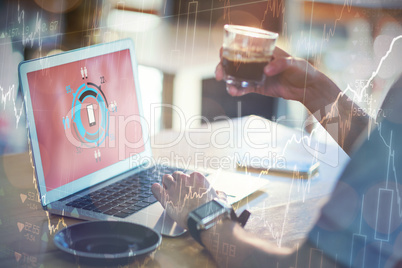 Man using a laptop while having cup of coffee