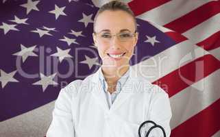 Composite image of smiling female doctor with stethoscope in hospital