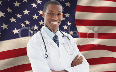 Composite image of smiling doctor with arms crossed in a medical office