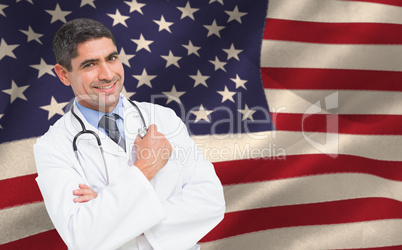 Composite image of smiling male doctor with arms crossed in hospital