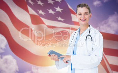 Composite image of happy doctor holding tablet pc