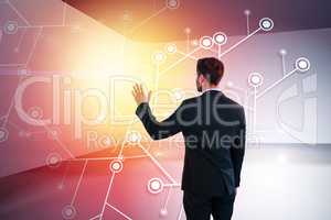 Composite image of rear view of businessman pretending to touch invisible screen