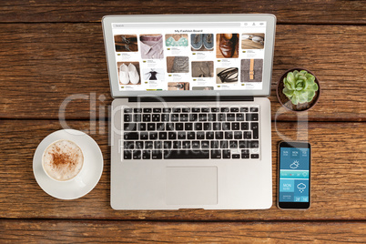 Composite image of overhead view of office desk with laptop and documents