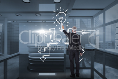 Composite image of rear view of serious businessman standing and writing