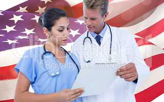 Composite image of male doctor with nurse discussing over clipboard