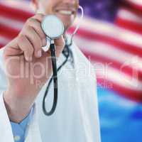 Composite image of doctor examining with stethoscope