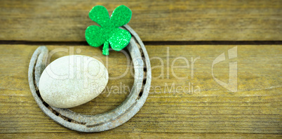 St Patricks Day shamrocks with horseshoe and pebble