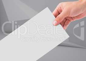 Composite image of Hand holding paper note against a neutral background