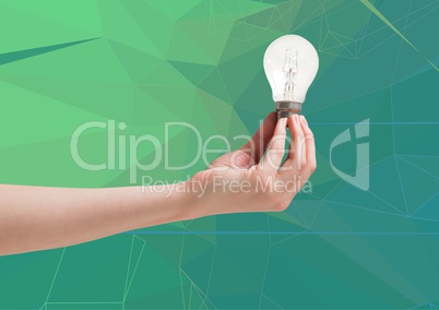 Composite image of Hand holding a light bulb against a green background