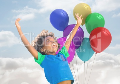 Kid with Balloons has Happy Fun against a cloudy background