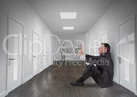 Composite image of Businessman sitting down on the floor against sketches on wall