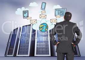 Composite image of Businessman Standing and  looking at icons against big folders in background