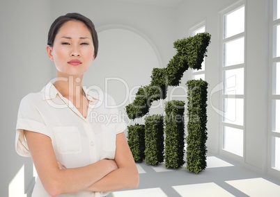 Businesswoman Standing in front of Graph against grey background