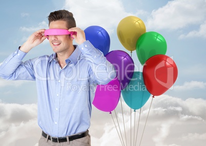 Man using VR Having fun with balloons against sky Background