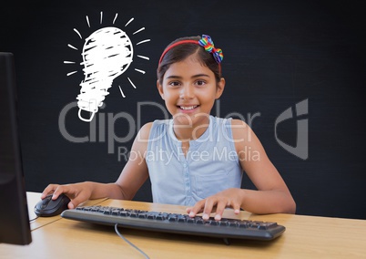 kid and blackboard with lightbulb using computer against a black background