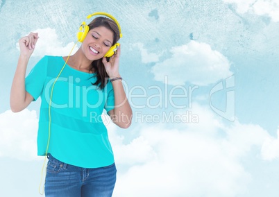Woman with headphones against sky against a blue background
