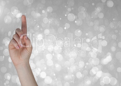 Composite image of hand Pointing bright Sparkles