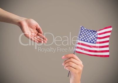 Composite image of Hands giving American Flag against grey background