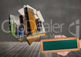 Composite image of Hand holding board against city architecture