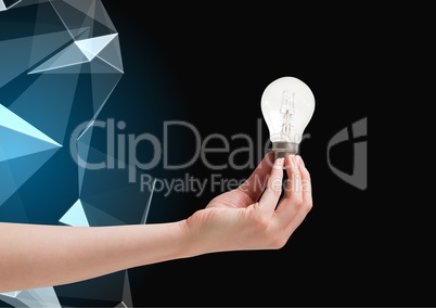 Composite image of Hand holding Lightbulb against graphic polygon in background