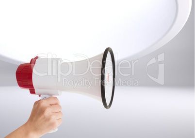 Composite Image of a Hand Holding a Loudspeaker against grey background