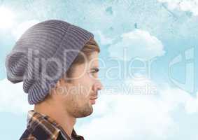 Man with beanie against sky with flare background