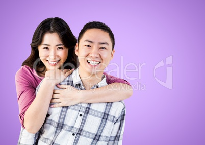 Portrait of a Happy Couple smiling against a purple Background