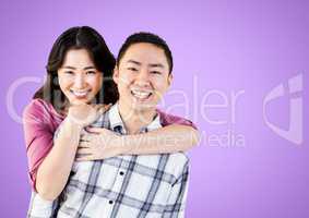 Portrait of a Happy Couple smiling against a purple Background