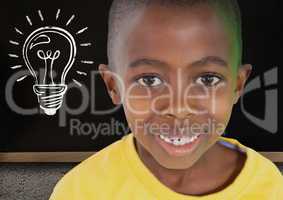 kid and blackboard with lightbulb against a black background