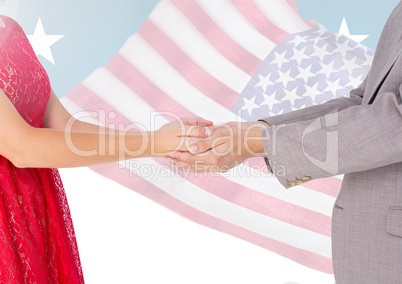 Composite image of couple holding hands against american flag