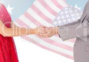Composite image of couple holding hands against american flag