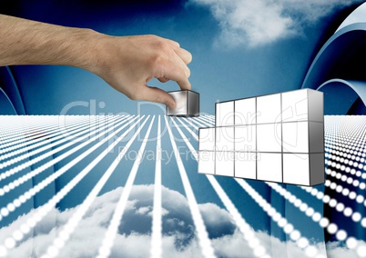 Composite image of Hand holding futuristic blocks against sky