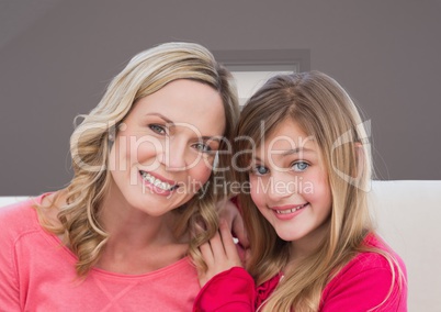 Mother and Daughter Smilling against a neutral background