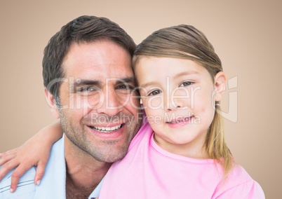 Father and his daughter smiling at camera against a neutral background