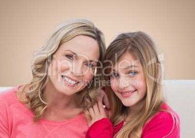 Mother and Daughter Smilling against a neutral background