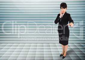 Businesswoman looking and pointing at camera against grey background