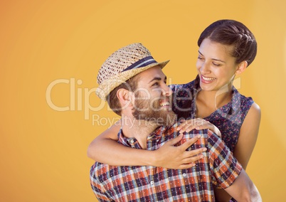 Happy Couple Hugging against a orange Background