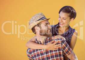 Happy Couple Hugging against a orange Background