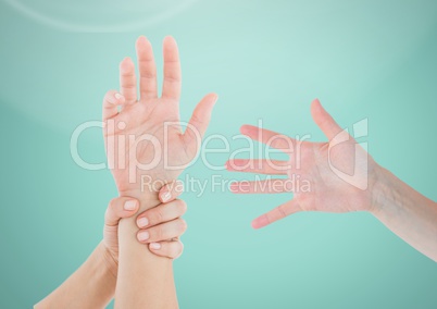 Three Hands holding one against light green background