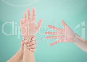 Three Hands holding one against light green background