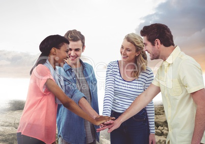 Happy Group of Friends cholding their hands against a Bright background