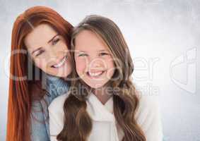 Mother and daugther against a neutral background