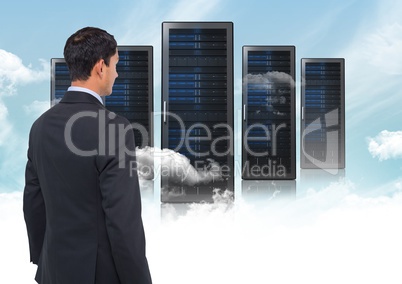 Composite image of Businessman Standing looking at folders against blue sky