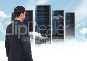 Composite image of Businessman Standing looking at folders against blue sky